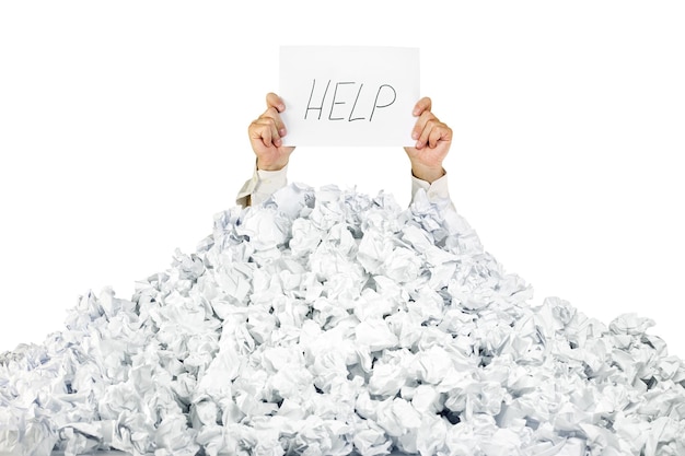 Person under crumpled pile of papers with a help sign isolated