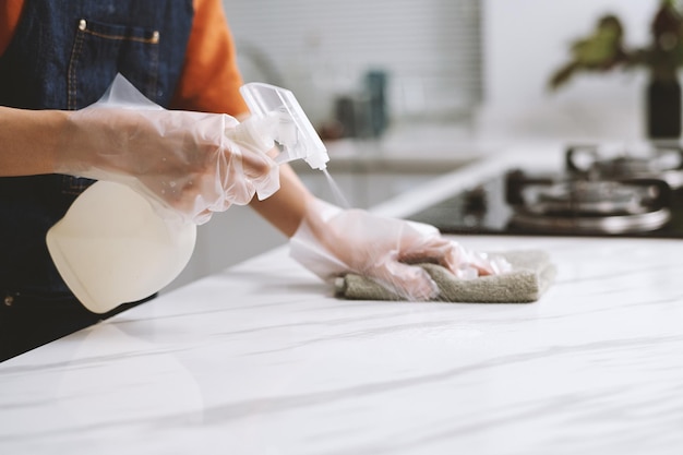 Person Disinfecting Kitchen Counter