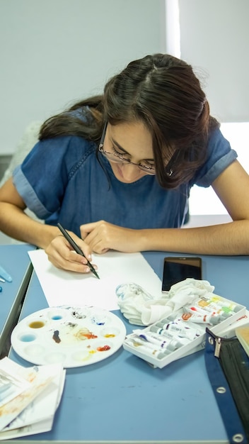 Person drawing by hand with pen pencil and ink architectural
perspectives in color