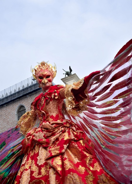 Person dressed up for Carnival of Venice wearing Fenix costume