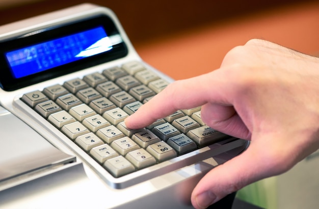 Person entering a sale on a cash register