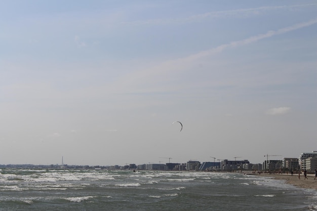 A person flying a kite over a body of water