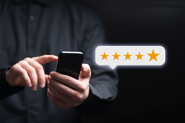 A person giving a five star rating online holding a smartphone customer review concept