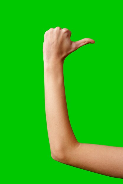 Person giving a thumbs up gesture against a green screen background