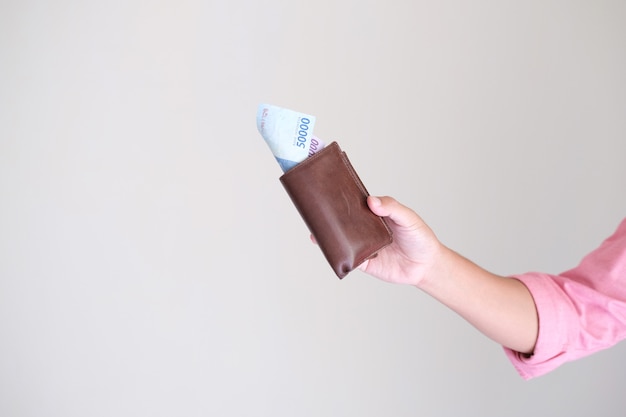 Photo person hand holding leather wallet with paper money shown isolated white background