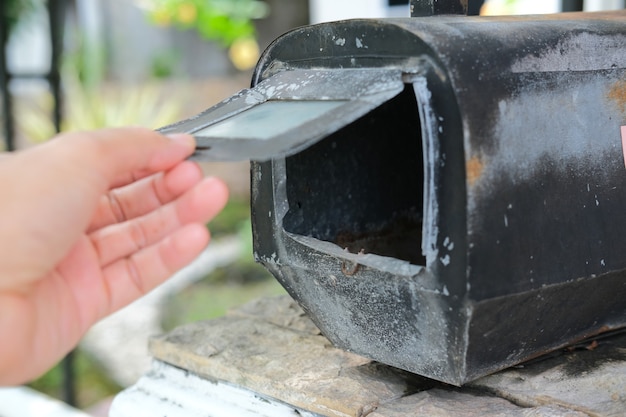 Person hand open the old mailbox