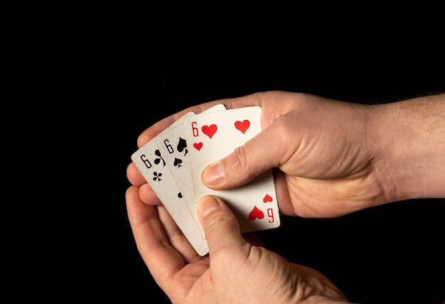 Photo person hands are holding playing cards three sixes