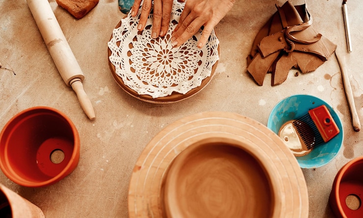 Photo above person and hands at pottery store with clay as artist for handmade manufacturing small business skills and entrepreneur with tools or equipment for handicraft creativity and design