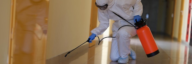 Person in hazmats are cleaned in corridor of hospital or public office