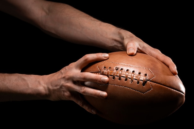 Photo person holding american football