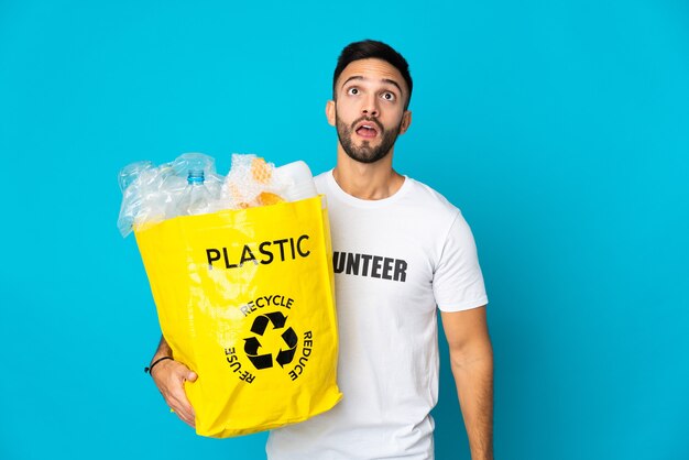 Person holding a bag to recycle