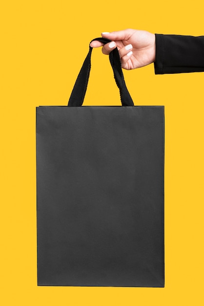 Person holding big black shopping bag