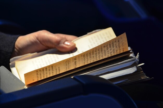 Person holding a book in shallow focus.