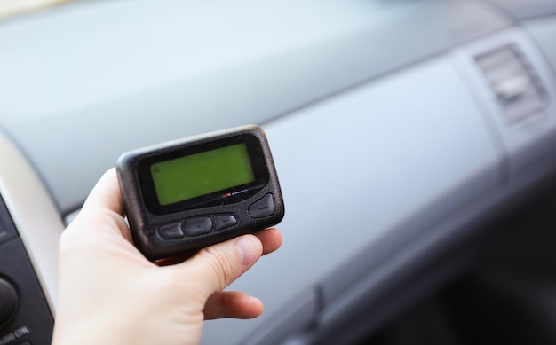 A person holding a device that says'auto repair'on it