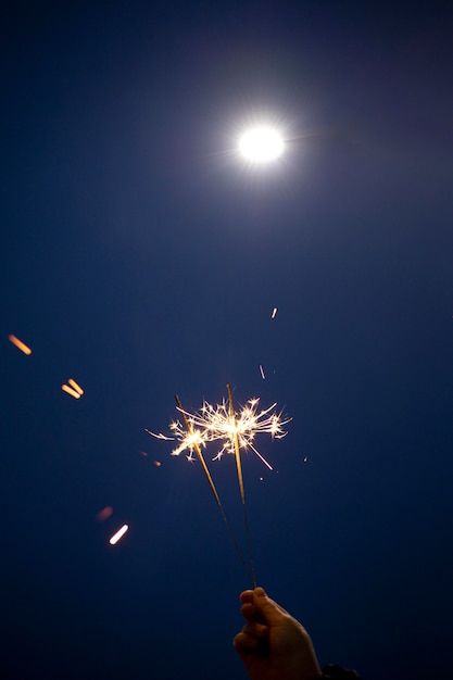 Photo person holding a festive sparkler