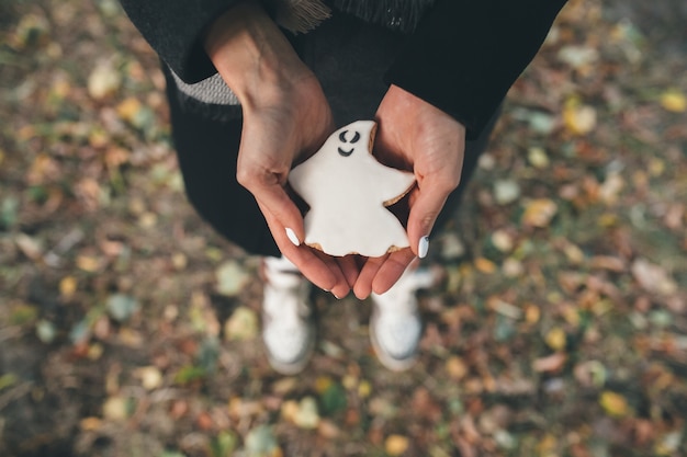 "Person holding ghost cookie"