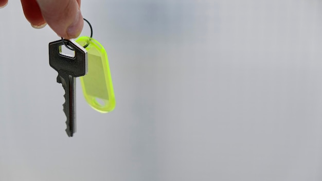 Person holding the keys to his new, very bright home. copy space