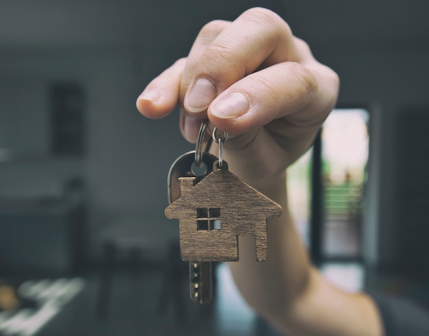 Photo person holding metal key in their hand