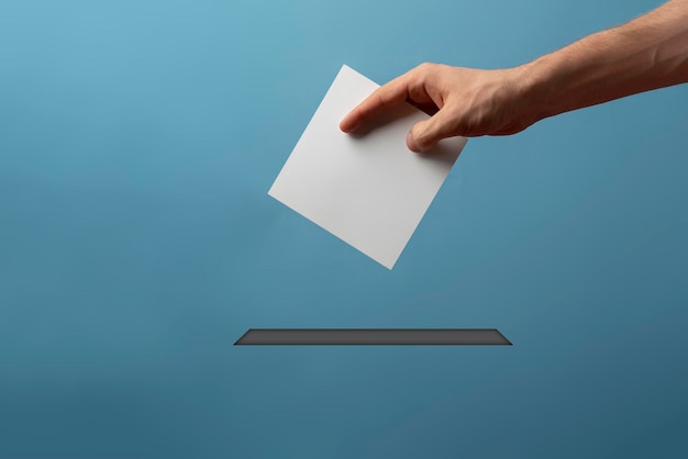 Photo a person holding a paper bulletin and drop it in the urn minimalistic vote concept