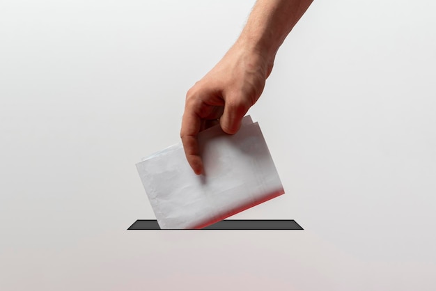 Photo a person holding a paper bulletin and drop it in the urn minimalistic vote concept