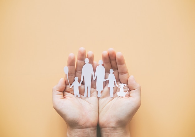 Person holding paper cut family