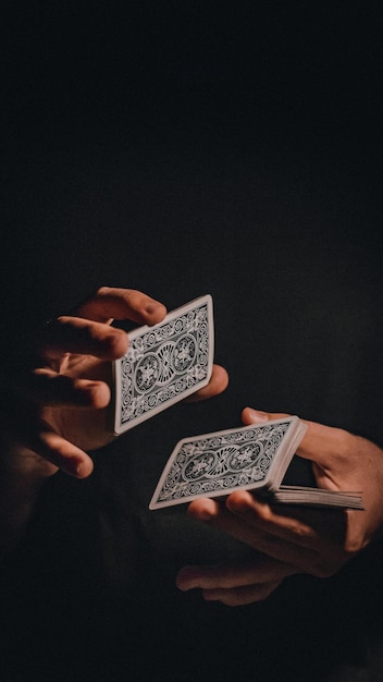 Photo a person holding a playing cards stock photo