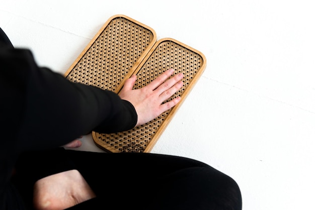 Photo person holding sadhu boards for nails standing practice cropped picrure