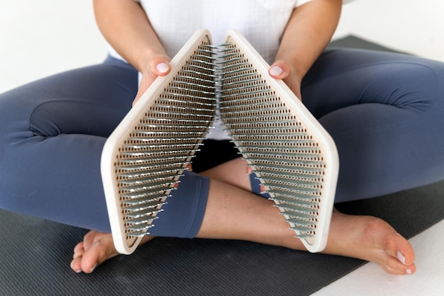 Photo person holding sadhu boards for nails standing practice cropped picrure