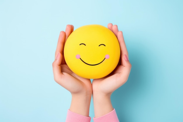 a person holding a smiley face ball