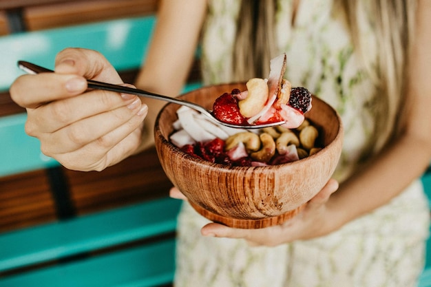 Person Holding Stainless Steel Spoon With Sliced Strawberries Stock Photo