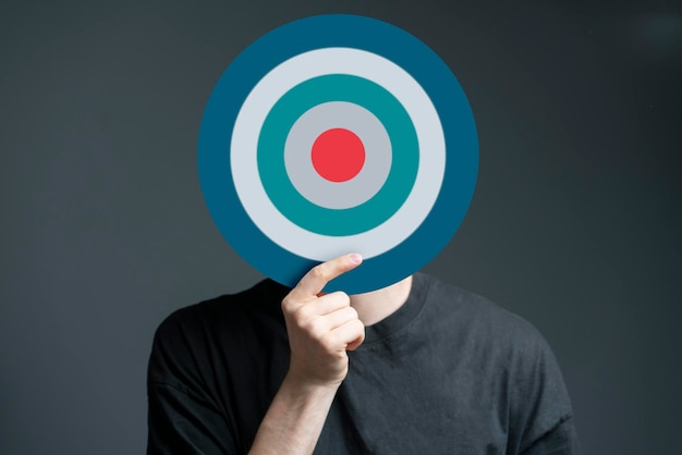 A person holding target in front of head internet sales targeting concept