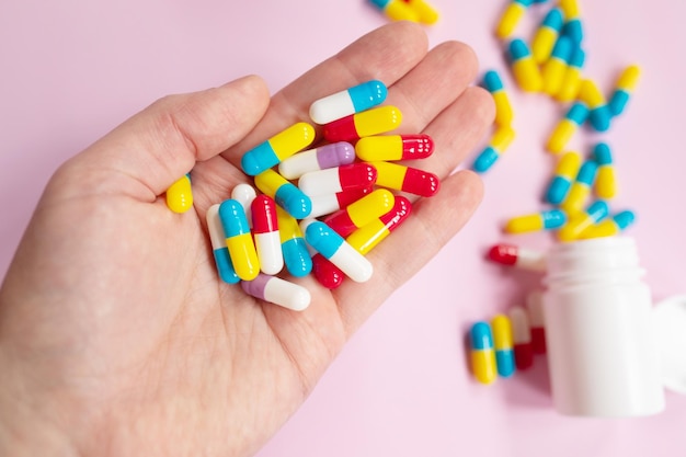 A person holds a bottle of medicine in their hand.