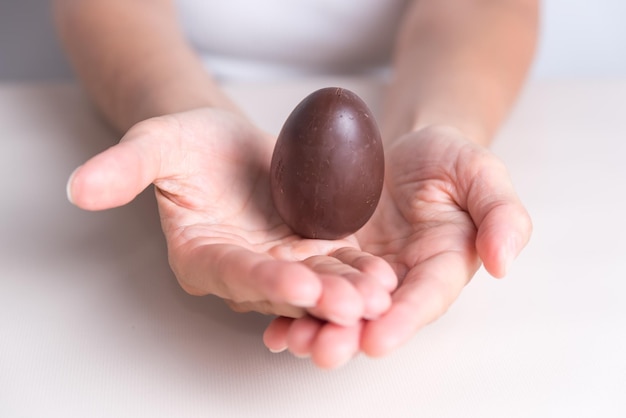 a person holds an egg with a white background