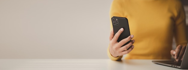 A person holds a mobile phone to use social media on a smartphone communicating via the Internet on a smartphone The concept of using technology in communication