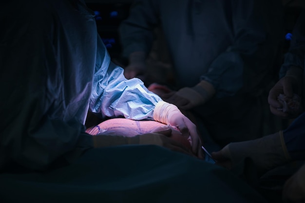 A person in a hospital bed is shown in an operating room.