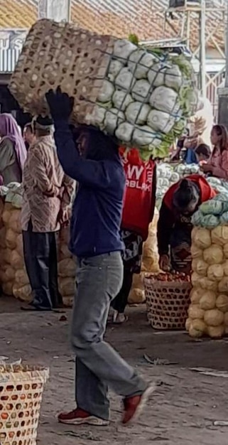 a person is carrying a bag of potatoes and a red sign that says w. w.