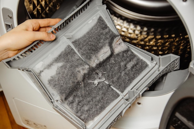 A person is cleaning a dirty air filter.