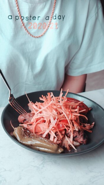 a person is eating a meal with a fork and knife