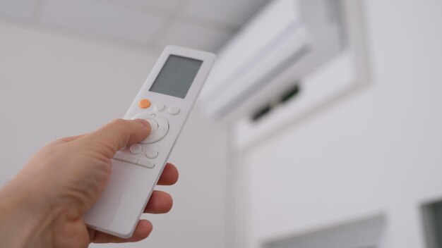 Person Is Holding Air Conditioner Remote Control