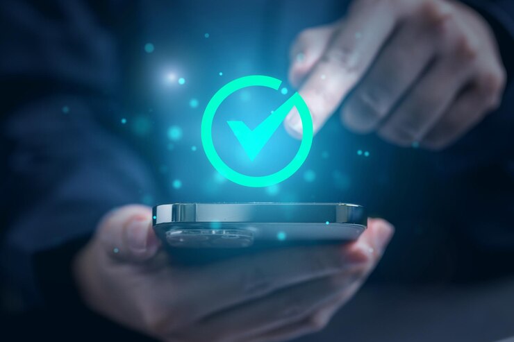 Photo a person is holding a phone with a green tick icon on the screen.
