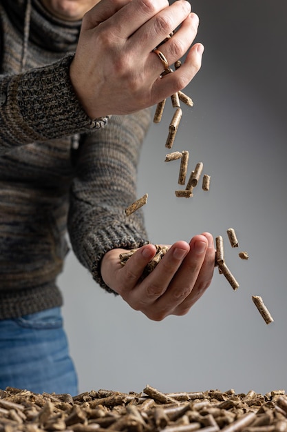 A person is holding a pile of dry food.