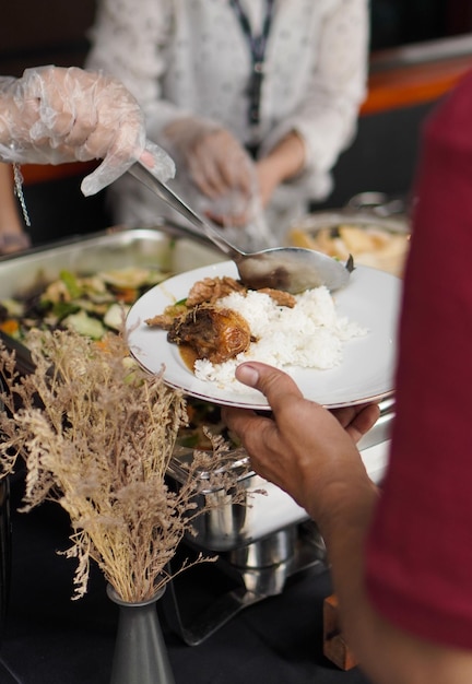 A person is holding a plate of food