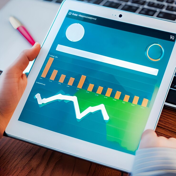 A person is holding a tablet with a graph on it.