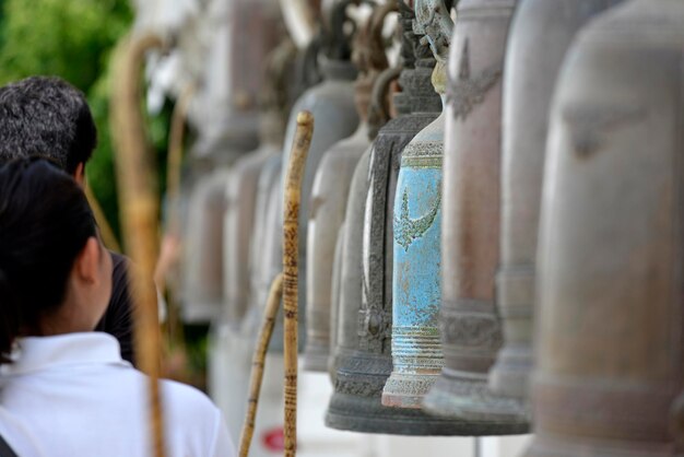 A person is knocking a old Buddhist bells