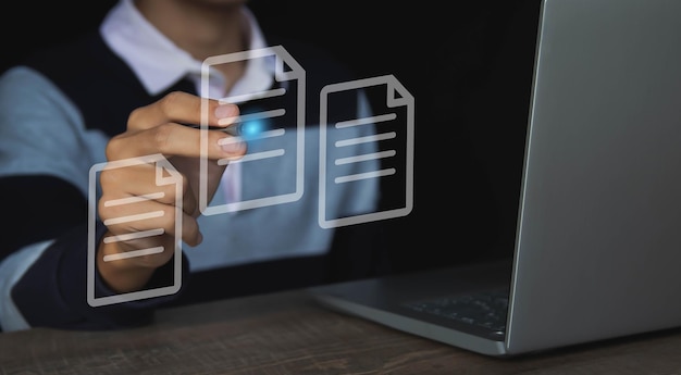 A person is working on a laptop with a document on the screen