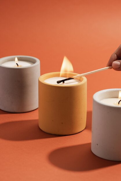 A person lighting a candle with a match on it.