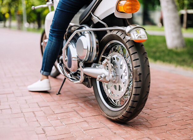 A person on a motorcycle is wearing jeans and a blue shirt.