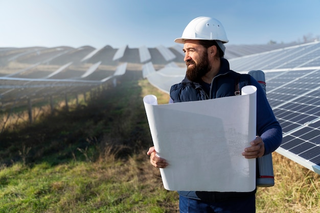 Foto persona vicino a un impianto di energia alternativa