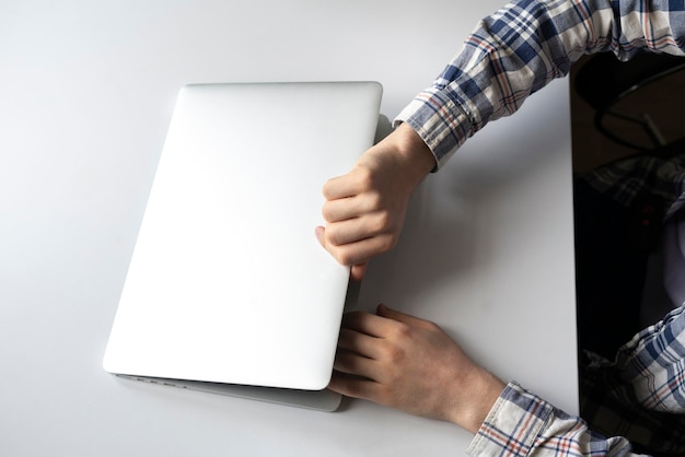 A person opens laptop computer to do some online work on project