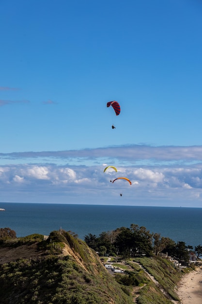 Person paragliding against sky